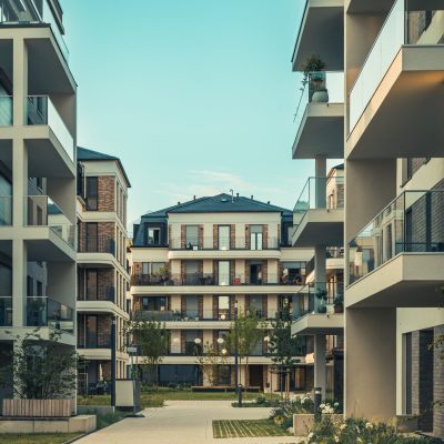 Contemporary cityscape featuring luxury apartments with balconies and outdoor pathways.